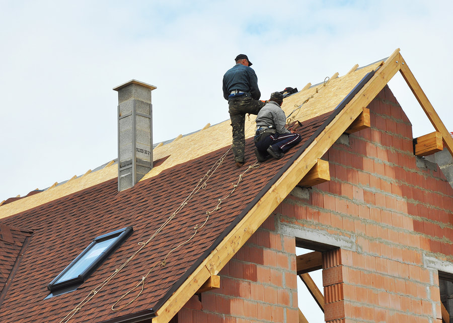 contractors repairing damage roof