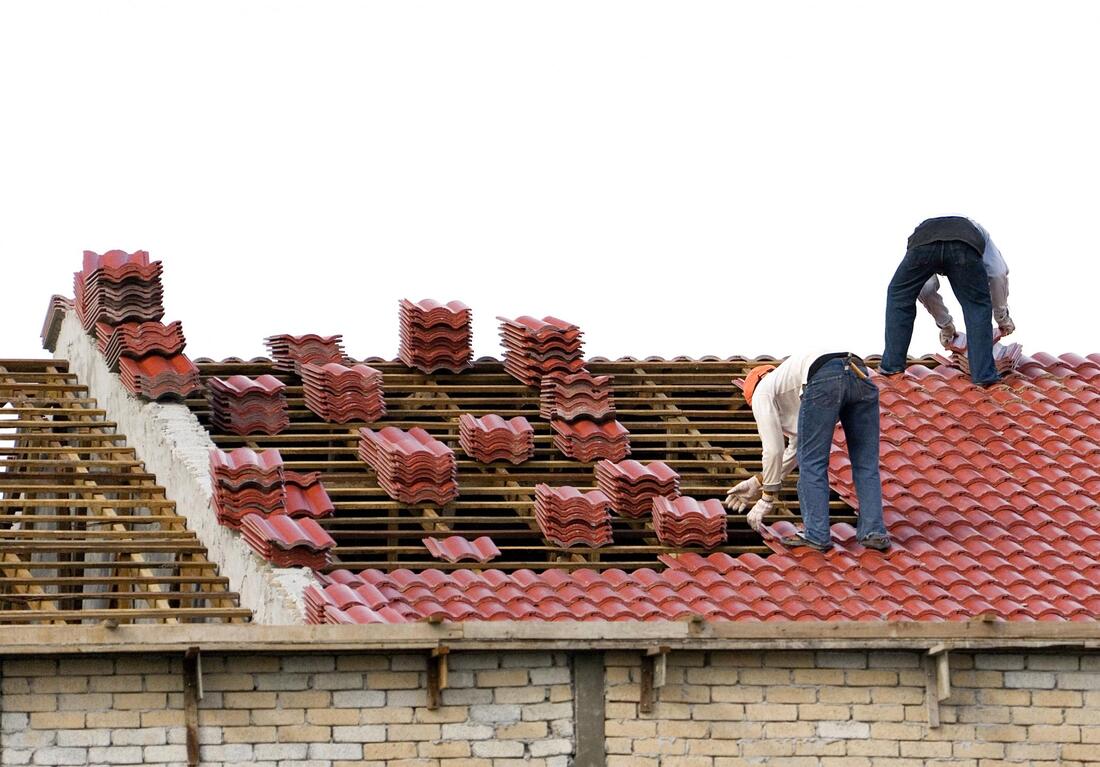 workers installing metal roof
